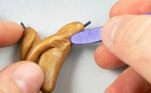 molded clay on wire being textured